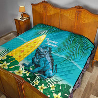 Turquoise quilt blanket on a bed with Cayman Islands text, yellow sail, and iguana