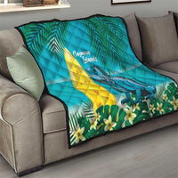 Turquoise quilt blanket draped on a sofa with Cayman Islands text and iguana artwork