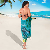 Turquoise beach sarong with iguana artwork and floral accents, tied at waist