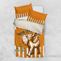 Orange football bedding set shown folded: striped pillowcases and elephant soccer print