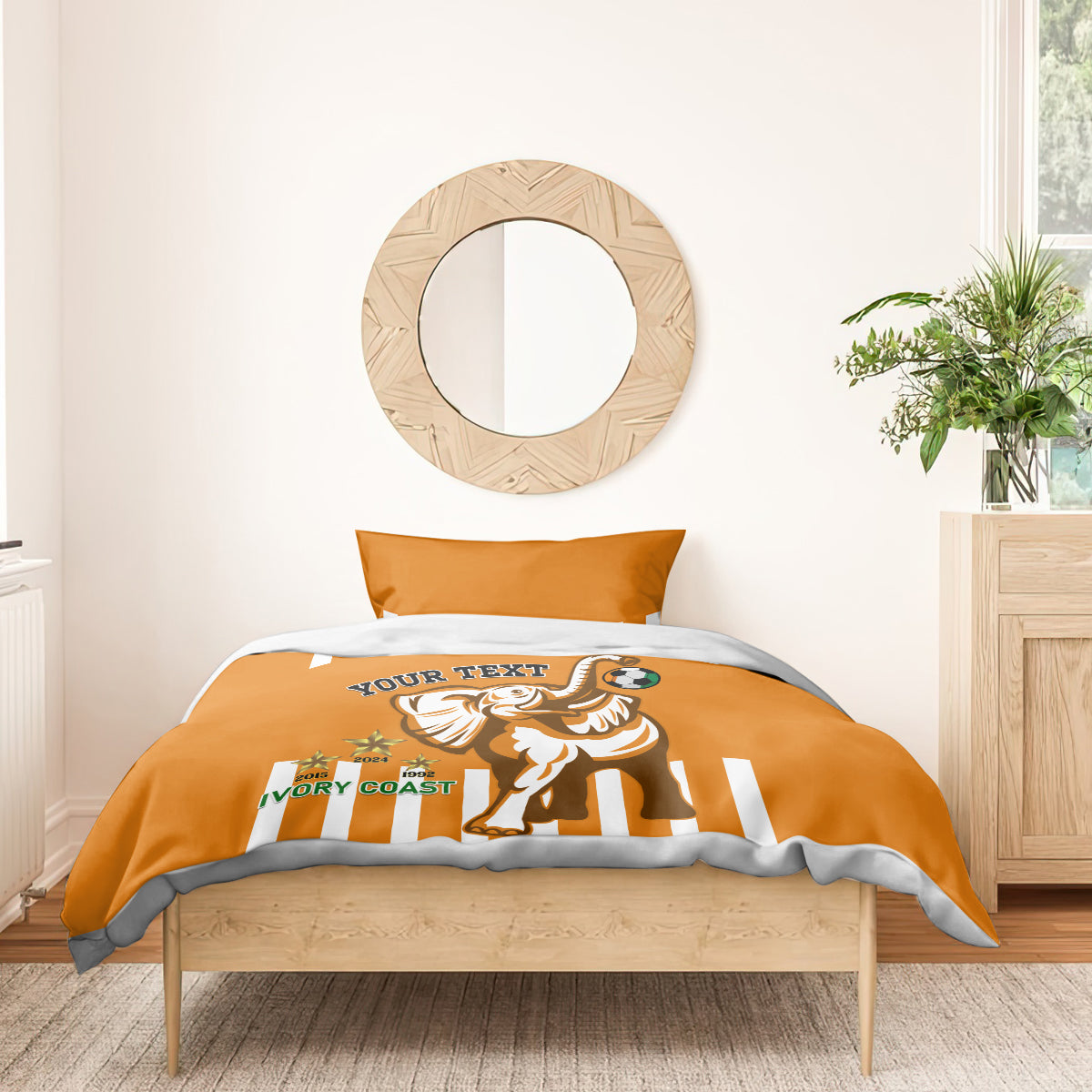 Orange football bedding set on bed: duvet with elephant soccer graphic and striped pillows
