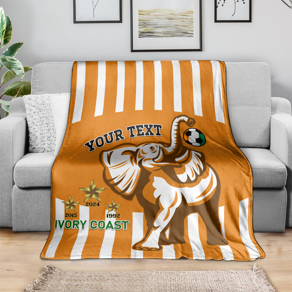 Football blanket in orange with white stripes, elephant mascot and soccer ball for custom text