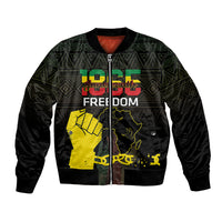 Black bomber jacket with green geometric pattern, yellow map and freedom graphic