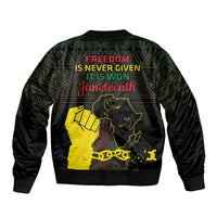 Black bomber jacket with green geometric pattern, yellow silhouette and freedom text