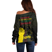 Women’s off-shoulder sweater back view, black with African pattern and Juneteenth text