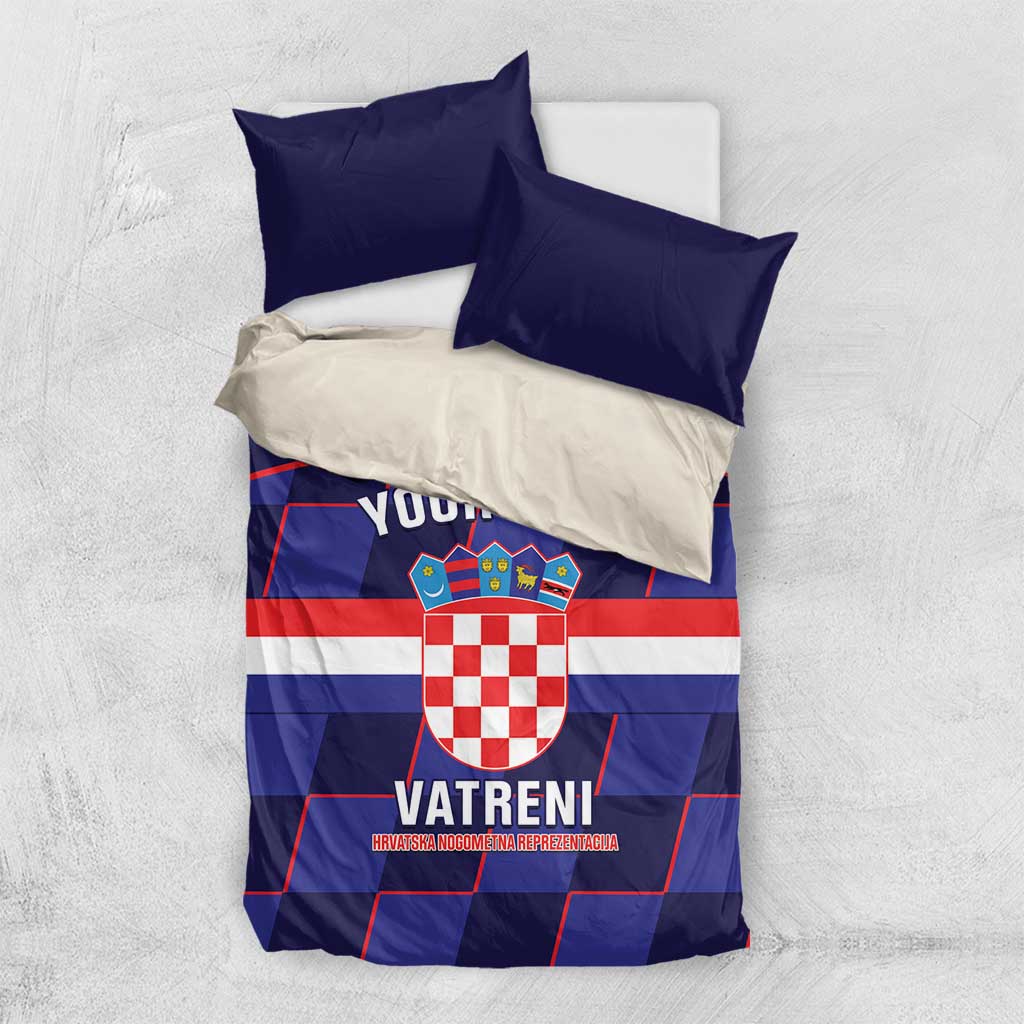 Blue and white bedding set with red-white crest and checker shield, plus two pillowcases