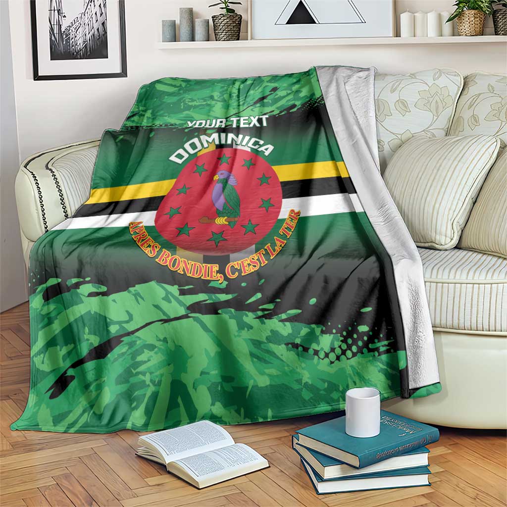 Green printed throw blanket with Dominica crest, stripes, and customizable text