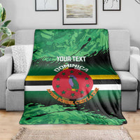 Green printed blanket with centered Dominica crest, stripes, and 'YOUR TEXT' header