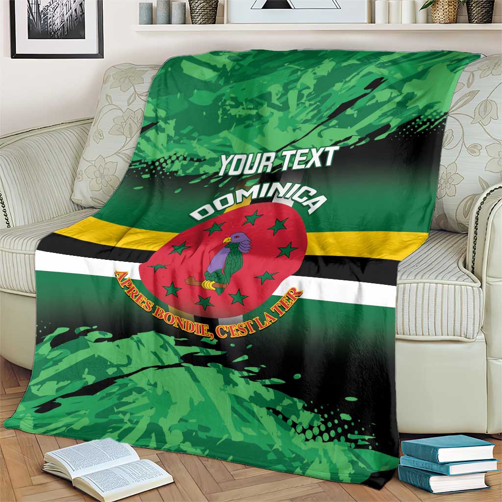 Green printed throw blanket with centered Dominica crest, stripes, and 'YOUR TEXT'