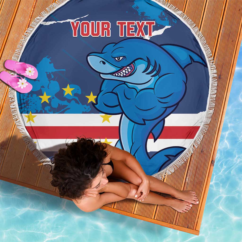 Round blue beach blanket with white fringe, shark mascot and “YOUR TEXT” on it