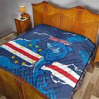 Blue quilt blanket on bed with shark mascot artwork, stars and stripes, and “Your text”