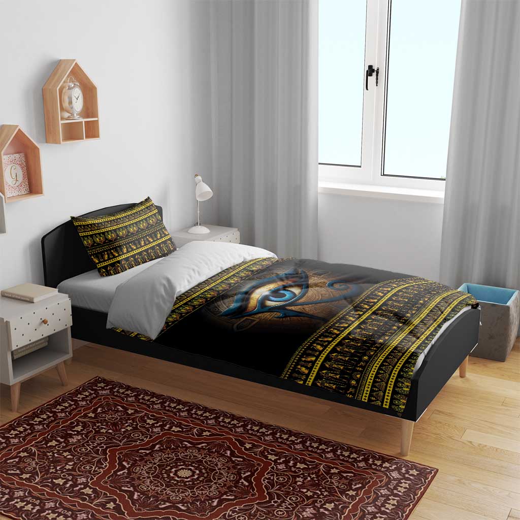Black duvet cover with blue Eye of Ra motif and gold ornamental stripes on bed