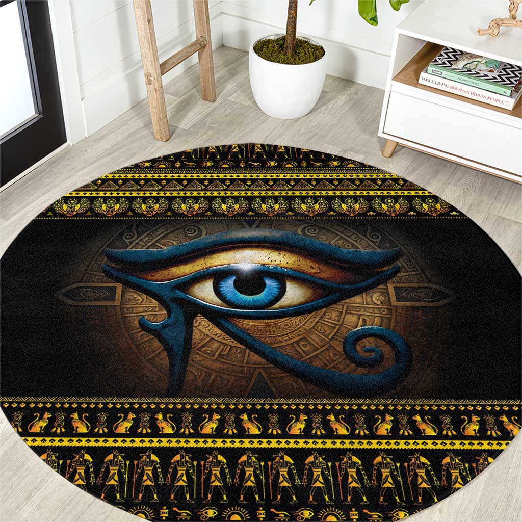 Black round carpet rug with blue Eye of Ra and gold geometric border
