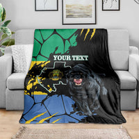 Black throw blanket with lion graphic, map-style design, and “YOUR TEXT” near center