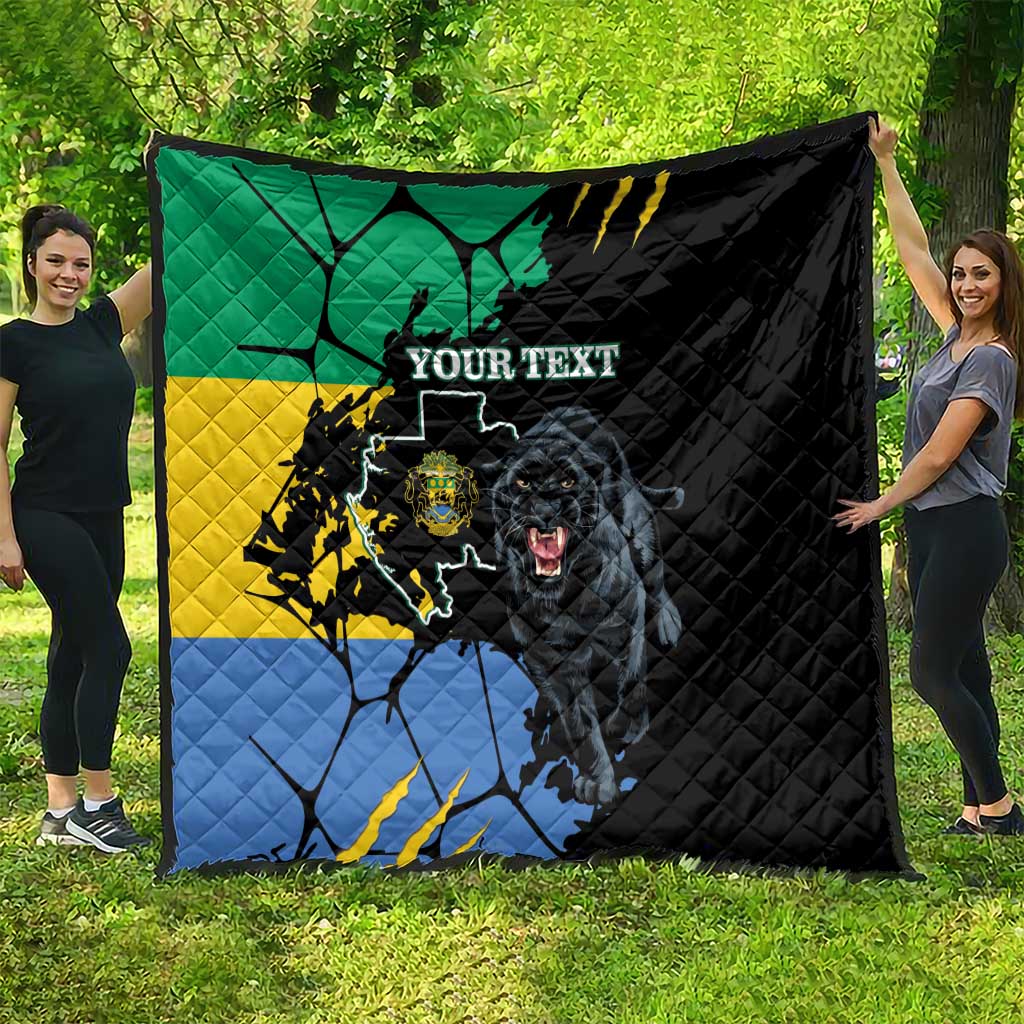 Black quilt spread on grass with green yellow blue flag map, panther face, custom text