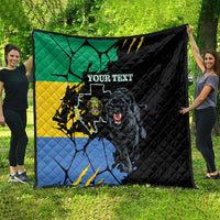 Black quilt spread on grass with green yellow blue flag map, panther face, custom text