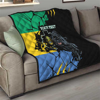Black quilt on a gray sofa, green yellow blue flag map with roaring panther and custom text