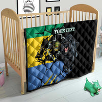 Black quilt on a baby crib, with green yellow blue flag map and roaring panther