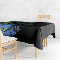 Black tablecloth with bold panther artwork on one side, over wooden dining table