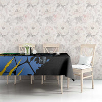Black and blue tablecloth featuring panther and map-style print, on dining set