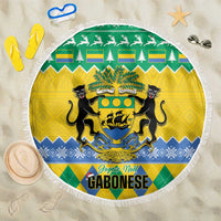 Round fringed beach blanket with green-yellow-blue coat of arms crest design