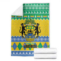 Green, yellow and blue Christmas blanket with coat of arms, pine trees and reindeer border, folded