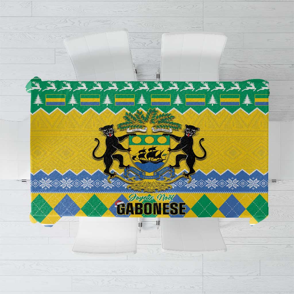 Green and yellow Christmas tablecloth with coat of arms, pine trees, and “Joyeux Noel”