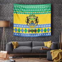 Gabon Christmas tapestry with green, yellow, and blue zigzag stripes and coat-of-arms crest
