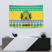 Wall-hung Gabon Christmas tapestry featuring coat-of-arms crest over green, yellow, and blue bands