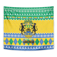 Gabon Christmas tapestry with coat-of-arms crest and green, yellow, and blue diamond and tree pattern