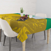Yellow tablecloth with green border, gold animal and leaf design on rectangular table
