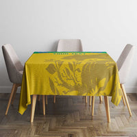 Yellow tablecloth with green trim and gold animal silhouette print on dining table