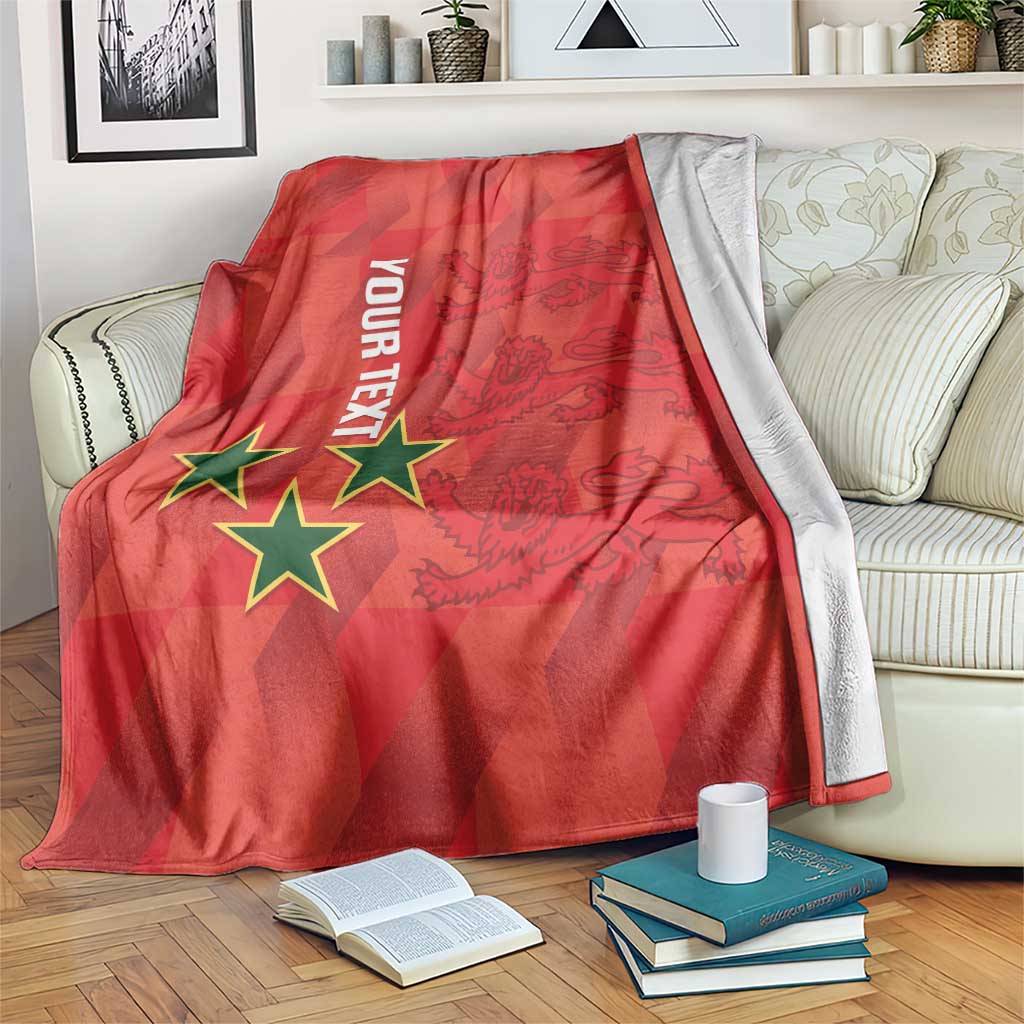 Red football blanket with green/yellow stars and graphic, draped on sofa