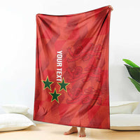 Red football blanket with stars and text graphic, held up like a hanging sheet