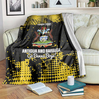 Black-and-yellow football blanket over a sofa with Antigua crest and “YOUR TEXT” print