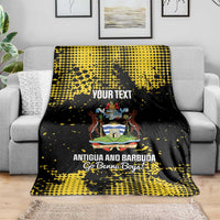 Black-and-yellow football blanket draped on a couch with Antigua crest and “YOUR TEXT”
