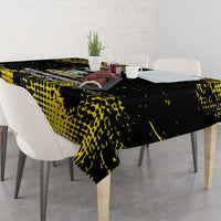 Black tablecloth with yellow speckled pattern, corner overhang on dining table