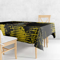 Black tablecloth with yellow speckled pattern, side drape over table edge