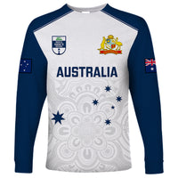 White long-sleeve cricket shirt with navy raglan sleeves, Australia crest and symbols