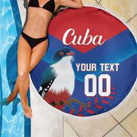 Round beach blanket with Cuba design, fringe edge, shown over a tiled pool area