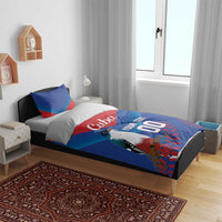 Blue and red bedding set on bed with two pillows, bird graphic, 'Cuba', 'YOUR TEXT'