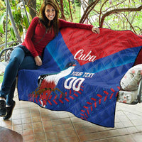 Blue and red Cuba quilt blanket laid on outdoor seating, bird graphic with 'Cuba' and 'YOUR TEXT 00'