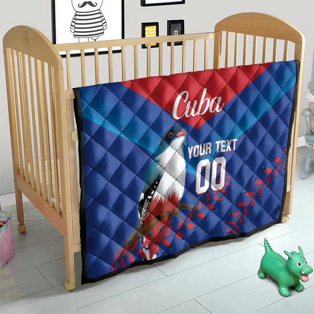Blue and red Cuba quilt blanket on baby crib, bird graphic with 'Cuba' and 'YOUR TEXT 00'