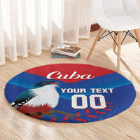 Round blue rug with Cuba word, bird illustration, and YOUR TEXT lettering.