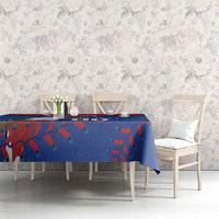 Blue tablecloth with red and teal tropical pattern on a long dining table