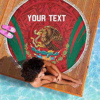 Round beach blanket showing 'YOUR TEXT' over red Aztec eagle, green rays, white fringe