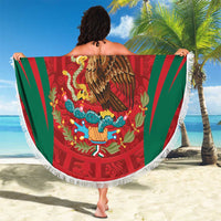 Round beach blanket with red Aztec eagle graphic, green striped rays, white fringe