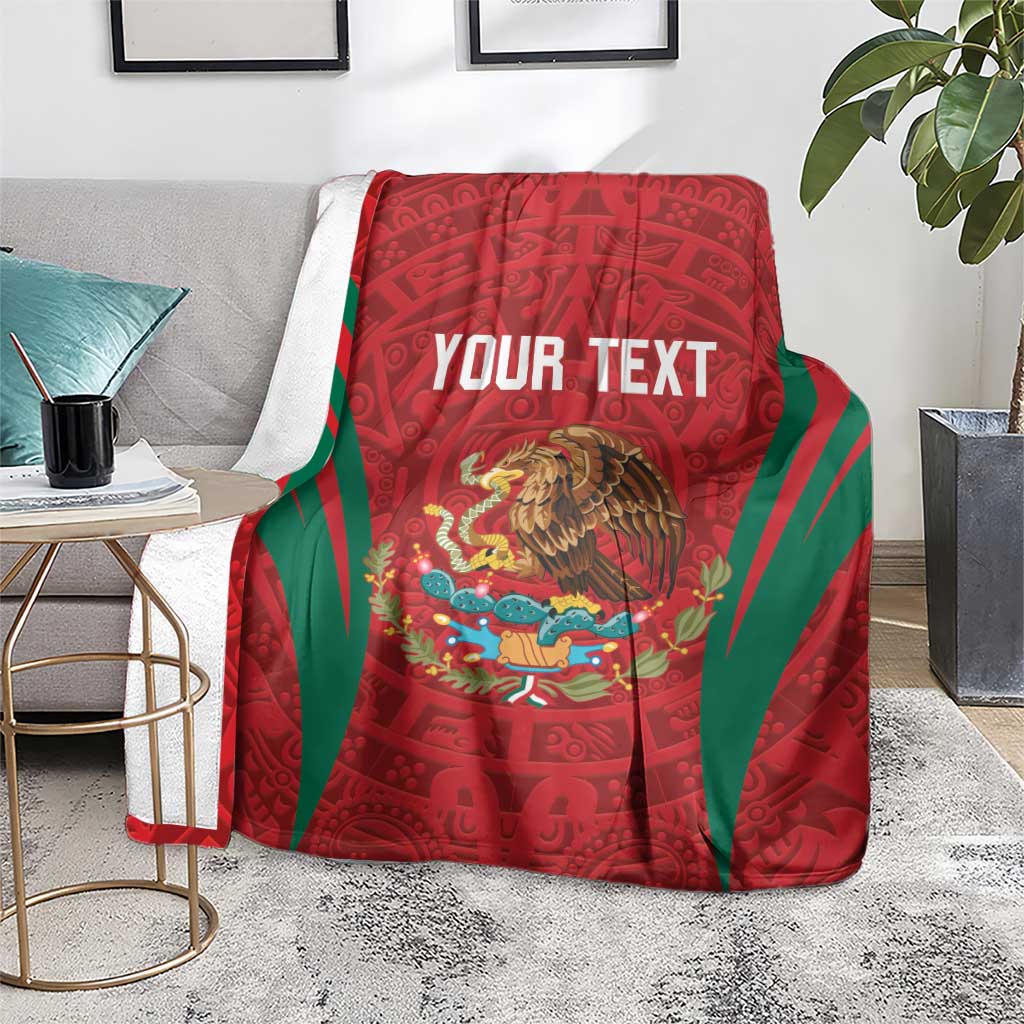 Custom blanket on sofa: red Aztec design with green stripes and central eagle and text