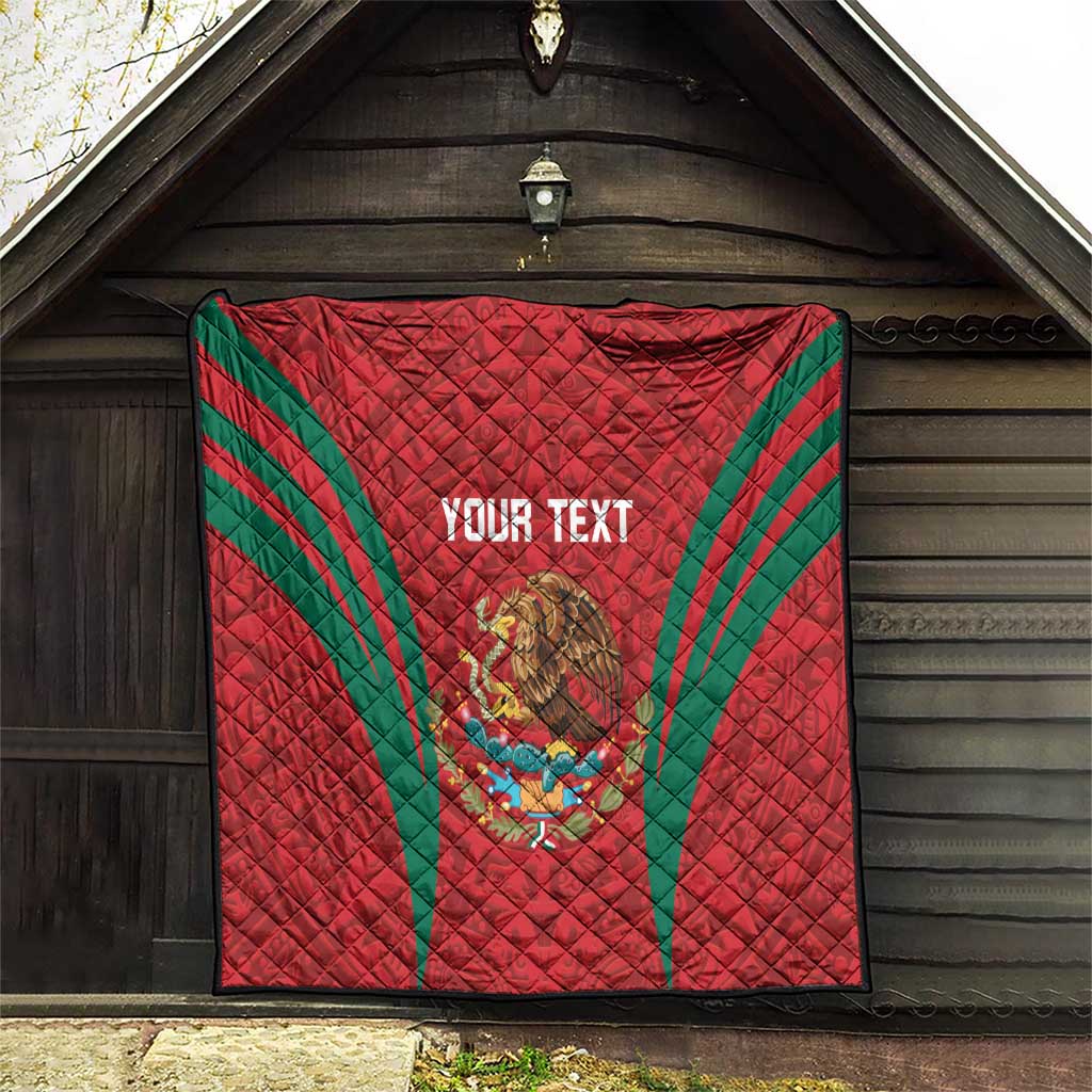 Red quilt blanket with green diagonal stripes, Mexico crest and 'YOUR TEXT' on hanging display