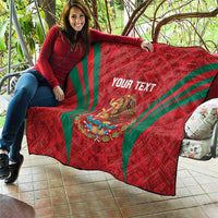 Red quilt blanket draped over couch with green diagonal stripes, Mexico crest and 'YOUR TEXT'
